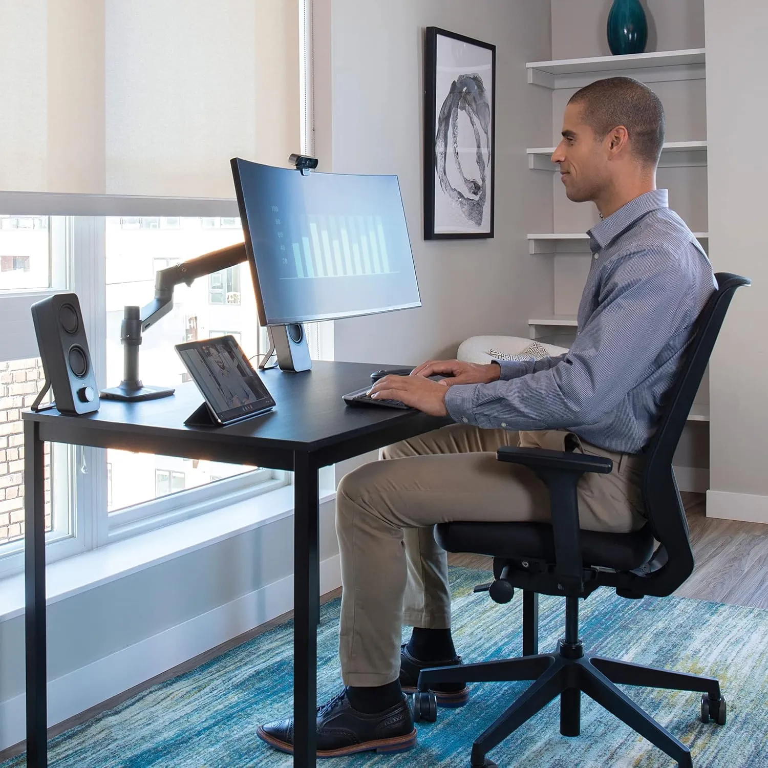 Ergotron LX single monitor arm mounted to a 120cm standing desk holding a 27 inch display