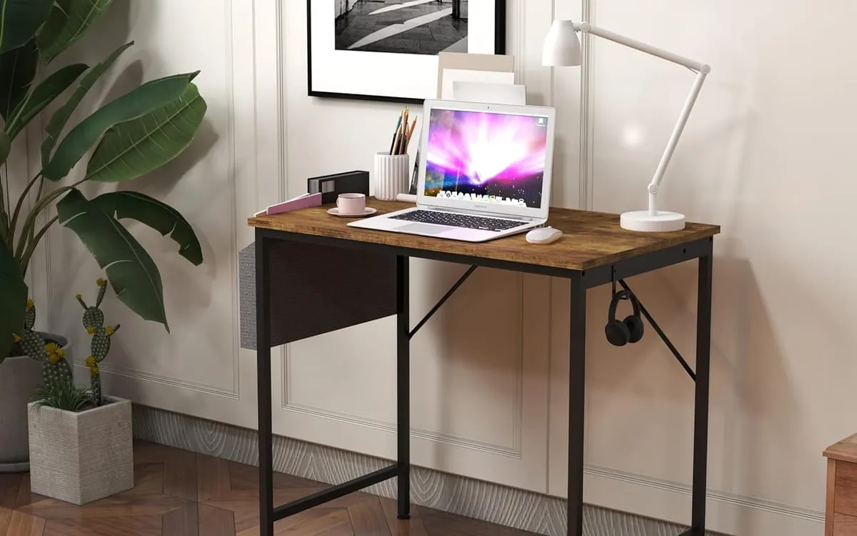 Panana computer desk in brown with a black metal frame, side storage bag, and hook