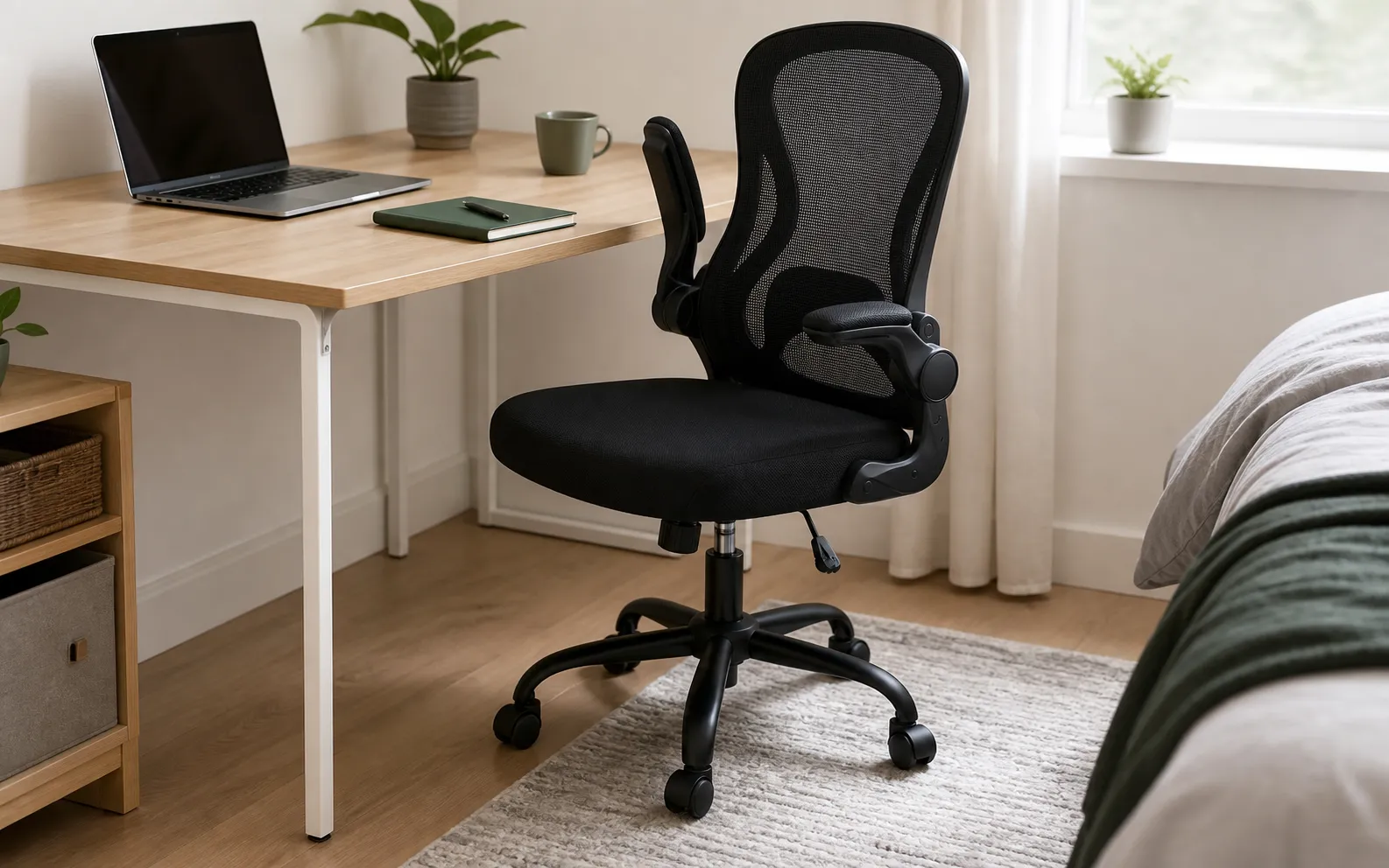 SONGMICS OBN042BH03 black mesh office chair with flip-up arms beside a compact bedroom desk