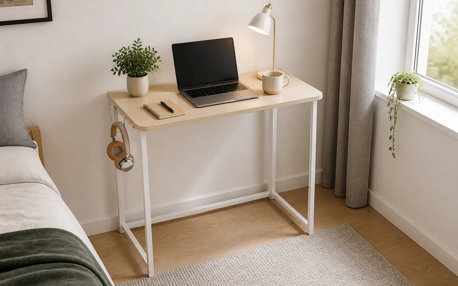 WOHOMO folding desk with pale oak top and white frame in a compact bedroom workspace